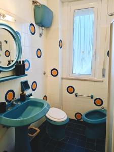 a bathroom with a sink and a toilet and a window at Suite Fronte Mare Senigallia- Terrazza Esclusiva sulla Spiaggia in Senigallia +11 photos