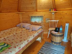 a bedroom with a bed in a log cabin at Anseküla Teelistemaja in Anseküla