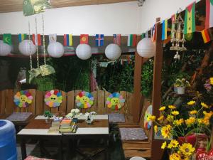 a room with a table and some flags and flowers at Aquing's Place in El Nido