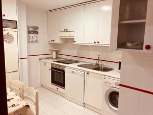 a white kitchen with a sink and a dishwasher at La Florida 43 in Soria
