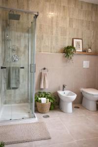 a bathroom with a shower and a toilet and a sink at Tenuta Maison Angelina in Formia +39 photos