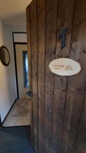 a bathroom with a wooden wall with a sink at Ferienwohnung Schäfer in Siegsdorf +59 photos