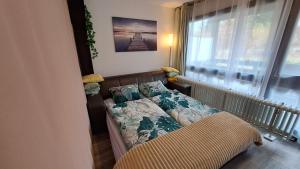 a small bedroom with a bed and a window at Ferienwohnung Schäfer in Siegsdorf