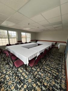 a conference room with a long table and chairs at GrandStay Hotel & Suites Hastings in Hastings +27 photos