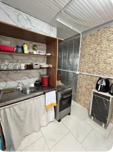 a small kitchen with a sink and a stove at Mirante Itajubá in Barra Velha