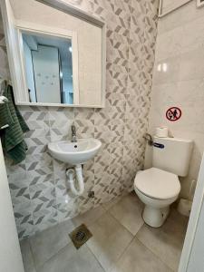 a bathroom with a toilet and a sink at N&M Apartment in Pirot +14 photos