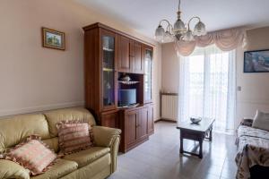 a living room with a couch and a tv at Casa Turistica Andora in Marina di Andora