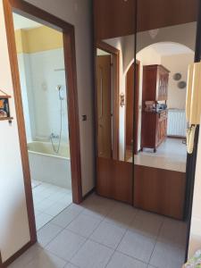 a bathroom with a shower and a tub and a mirror at Casa Turistica Andora in Marina di Andora