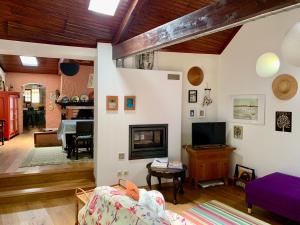 a living room with a couch and a fireplace at Casa do Paço Aveiro - HolidayHome in Aveiro