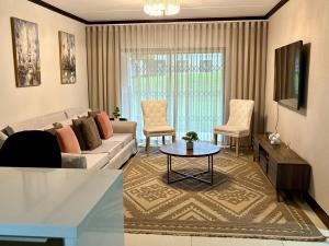 a living room with a couch and a table at The Calm Corner in Trevallyn