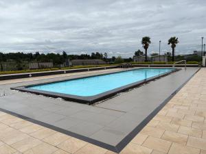 a large swimming pool with blue water at The Calm Corner in Trevallyn