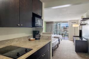 a kitchen with a counter top in a room at Skyline Island Colony Hotel in Honolulu