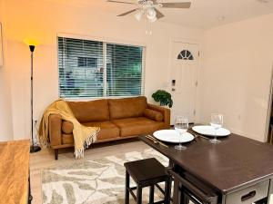 a living room with a couch and a table with wine glasses at Golden Sol Casita in Tempe