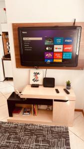 a flat screen tv sitting on top of a tv stand at Aconchego - com Garagem in Santa Maria +11 photos