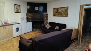 a living room with a couch and a fireplace at Casas Rurales Villa Vicenta in Alcalá del Júcar