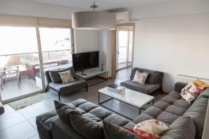 a living room with a couch and a tv at "AcroPool" Penthouse with Private Pool & Acropolis View in Athens
