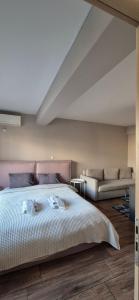 a bedroom with a large bed and a couch at "AcroPool" Penthouse with Private Pool & Acropolis View in Athens +28 photos