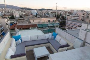 a balcony with white furniture and a view of a city at "AcroPool" Penthouse with Private Pool & Acropolis View in Athens