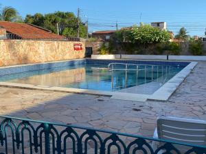 a swimming pool in front of a building at Pousada Costa Azul in Paulista