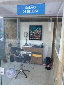 a shop window with a chair and a desk at Pousada Costa Azul in Paulista +8 photos