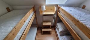 a small room with two bunk beds and a lamp at Chalupa Špičák in Jablonec nad Nisou