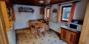 a small kitchen with a table and a microwave at Chalupa Špičák in Jablonec nad Nisou