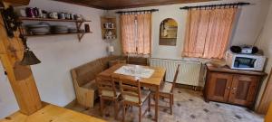 a dining room with a table and a microwave at Chalupa Špičák in Jablonec nad Nisou +12 photos