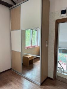 a mirror in a room with a table and a window at Loft Studio in Igalo
