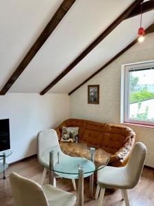 a living room with a couch and a table at Loft Studio in Igalo +4 photos