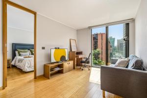 a bedroom with a bed and a large mirror at Nest Collection El Golf in Santiago +129 photos