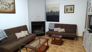 a living room with two couches and a fireplace at Casas Rurales Villa Vicenta in Alcalá del Júcar