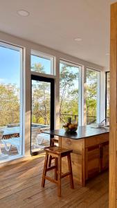 a kitchen with a counter with a table and windows at Altos de Santa Catalina in Soná