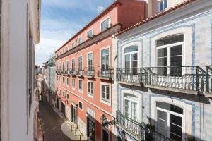 a group of buildings with balconies on a street at Correio Velho Hotel in Lisbon
