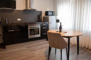 a kitchen with a wooden table and a refrigerator at Apartments-Altenahr in Altenahr