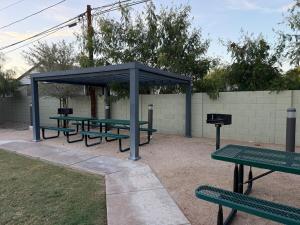 a picnic shelter with green picnic tables and a grill at Azure Casita in Tempe