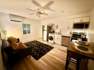 a living room with a kitchen with a ceiling fan at Azure Casita in Tempe