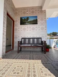 a bench sitting in a room with a rug at R's Bolli Kudike in Madikeri