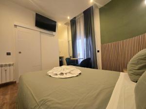 a hotel room with a bed with a towel on it at Hostal Main Street Madrid in Madrid +38 photos