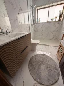 a white bathroom with a sink and a toilet at Casa São Domingos 2 in Lousada +22 photos
