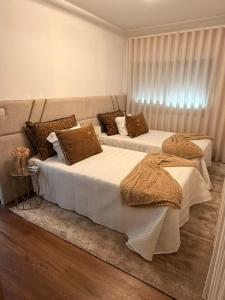 two beds sitting next to each other in a bedroom at Casa São Domingos 2 in Lousada