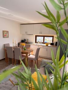 a kitchen and dining room with a table and chairs at Casa São Domingos 2 in Lousada