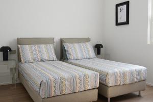 two beds sitting next to each other in a bedroom at Rhapsody on the Lake in Lezzeno