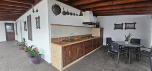 a kitchen with a sink and a table with chairs at La Barbacoa in Dos Pinos