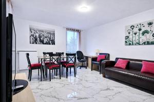 a living room with a couch and a table and chairs at Paris & Disney - 5 mins from Train Station - Champs Harmony in Champs-sur-Marne +8 photos