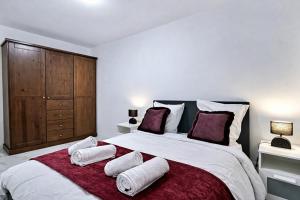 a bedroom with a large bed with three pillows on it at Paris & Disney - 5 mins from Train Station - Champs Harmony in Champs-sur-Marne