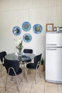 a dining room with a table and a refrigerator at Cabaña 3 del Puerto Gol in Santo Tomé