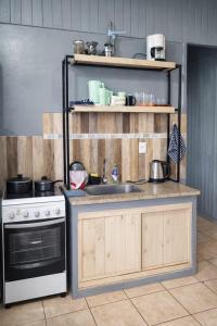 a kitchen with a sink and a stove at Cabaña 3 del Puerto Gol in Santo Tomé
