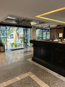 a lobby with a bar in a building at Hotel Oscar Gold Savassi in Belo Horizonte