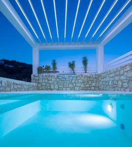 a swimming pool in a villa with a stone wall at Dion Villa Zakynthos Greece in Zakynthos