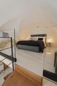 a bedroom with a bed and a glass table at Golden Suite in Stornarella